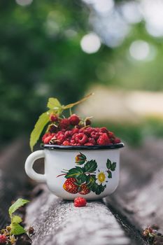 Cup of fresh raspberries. Concept for healthy nutrition. Rustic background. Close up