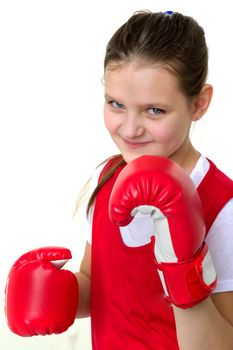 Sports boxer teenage girl. Close up portrait of beautiful girl in red sports uniform and boxing gloves doing boxing exercises. Teenager child posing in studio on white background