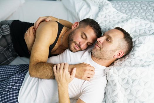 Gay couple in a romantic moment in bed. Homosexual lifestyle concept.