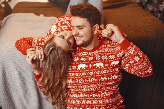 People in a Christman decorations. Man and woman in a red sweater. Family at home.