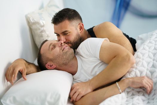 Gay couple in a romantic moment in bed. LGTB concept.