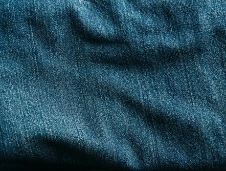 Rough blue jeans denim texture background, closeup.