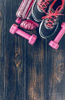 Sneakers dumbbells and a bottle of water. Flat view. All in one color.