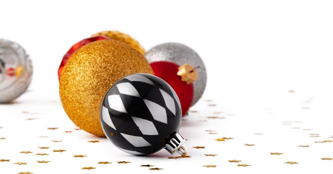 Pile of Christmas baubles isolated on white background, close up