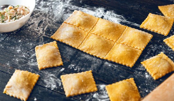 Woman chef cooks step by step the traditional ravioli