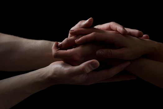 Concept of salvation. Hands of two people rescue, help. Helping hand, support. Isolated arm on black, charity. Devoted and empathy. Couple relationship