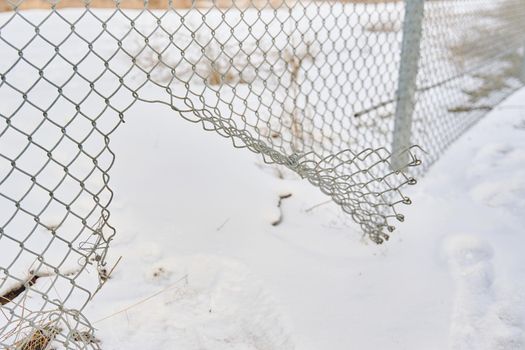 Hole in wire border fence. Maximum security detention facility. Illegal trespassing. Escape from prison or closed institution for mentally ill. Winter snowy weather. Unauthorized entry is prohibited.