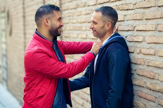 Gay couple in a romantic moment on the street. Homosexual relationship concept.