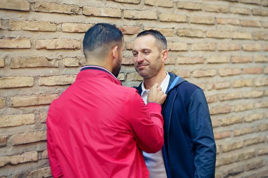 Gay couple in a romantic moment on the street. LGTB relationship concept.