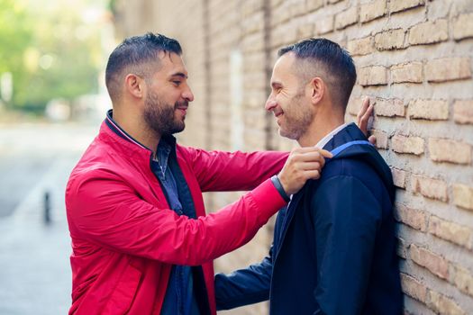 Gay couple in a romantic moment on the street. LGTB relationship concept.