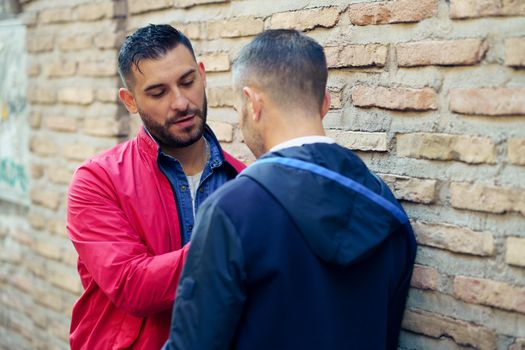 Gay couple in a romantic moment on the street. LGTB relationship concept.