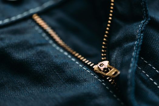 Zipper of denim jeans, closeup detail.