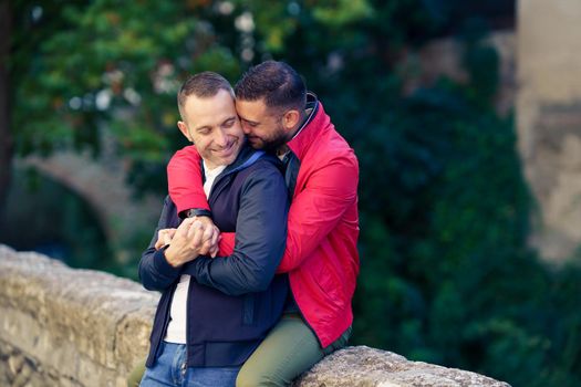 Gay couple in a romantic moment in a beautiful place near the river. LGTB relationship concept.