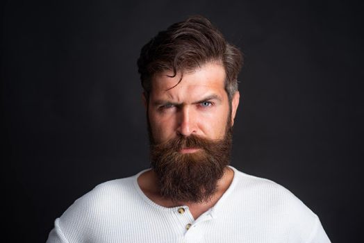 Young handsome man with long beard, mustache and trendy hairdo