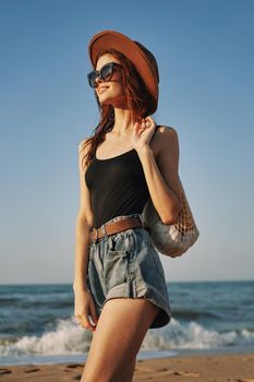 woman walking on the beach landscape sun fun lifestyle. High quality photo