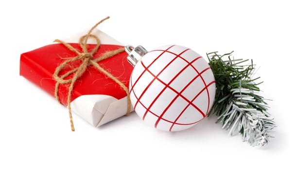 Christmas baubles and festive gift box isolated on white background, close up