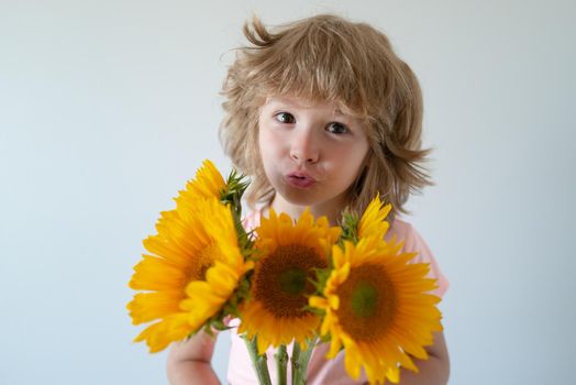 Kid with flowers. Lovely romantic child. Funny kids face