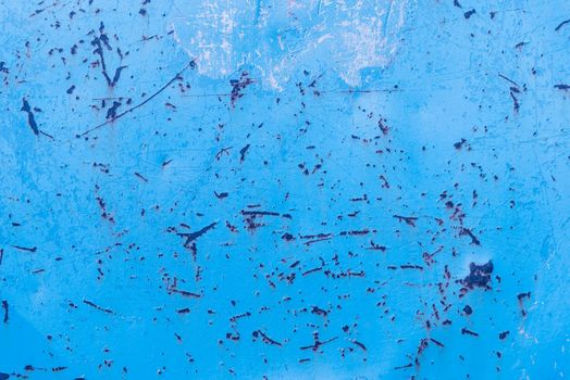 Old scratched metallic background of blue color, texture.