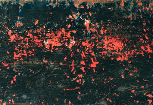 Old scratched metallic surface of black and red color, texture.