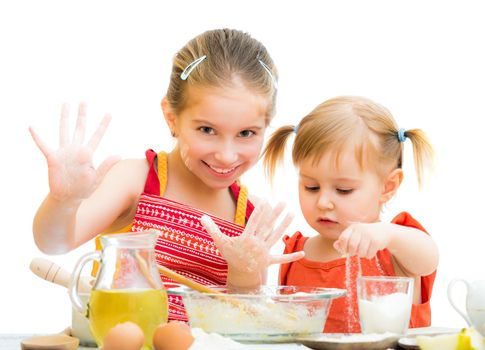 cute little sisters baking on kitchen and shows hands isolated on a white background