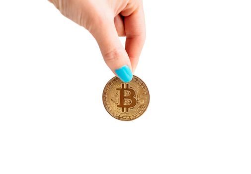 Woman’s hand with gold coin bitcoin on a white background, symbol of crypto currency.