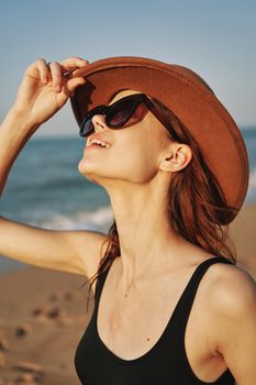 cheerful woman in sunglasses Sandy coast landscape sun. High quality photo