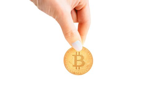 Woman’s hand with glowing gold bitcoin on a white background, copy-space.