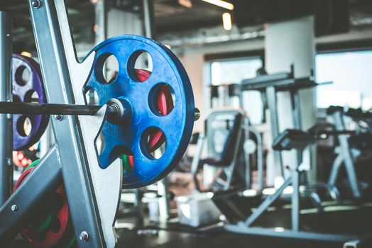 Rod with weights in the gym