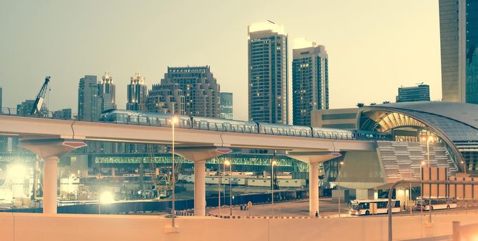 Metro bridge with train at the Sheikh Zayed Road in Dubai in the evening, United Arab Emirates