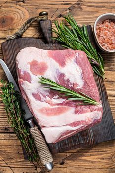 Pork Neck raw meat piece on wooden cutting board. wooden background. Top view.