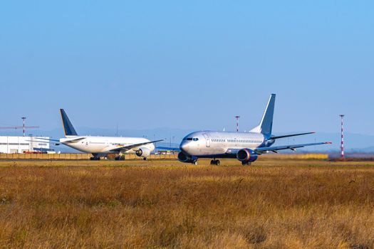 Passenger plane taking off from runway at airport on sunny day photo