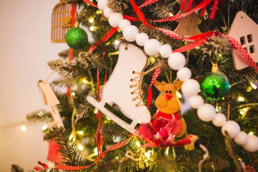Christmas and New Year background with Eve Tree decorations. Wooden handmade skates as toy for holiday fur .