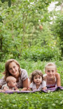 Happy family on green grass in the garden