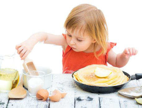 cute little baby girl with pancakes isolated on a white background