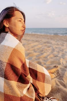 Young woman relaxing on sand beach near the sea, summer vacations.
