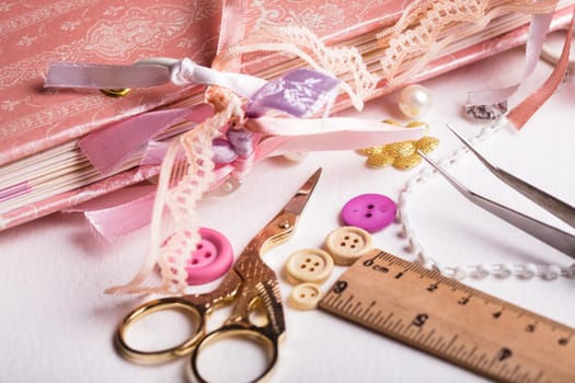 making scrapbooking album with rings and decorations on the table and tools