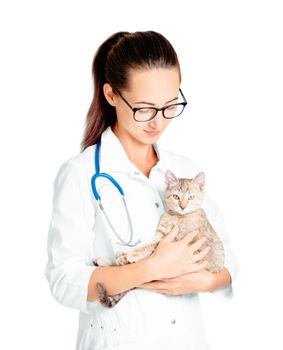 Young woman doctor veterinarian wearing in a white coat with stethoscope holding a kitten.