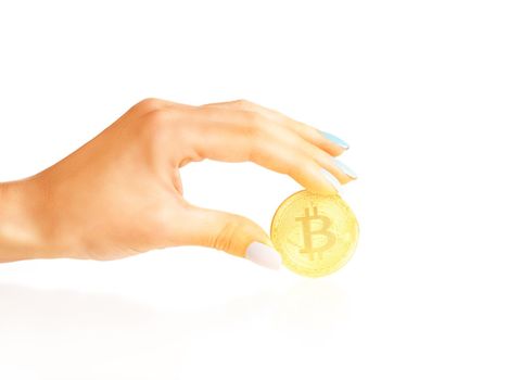 Bitcoin - symbol of crypto currency in a female hand on a white background.