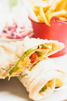 Fresh pita sandwich with French fries and salad