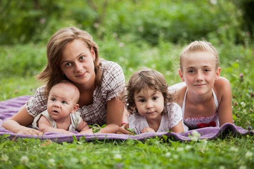 Happy family on green grass in the garden