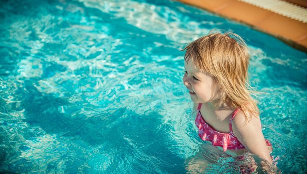 little cute girl near the pool