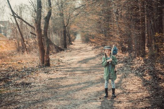 little girl goes through the woods with stuff, photo in vintage stylev