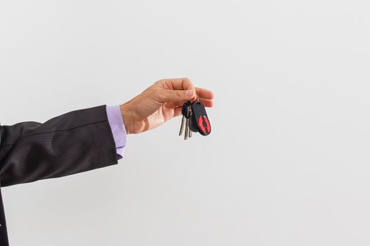 businessman holding a car key