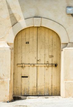 wooden garage doors in a street of Valletta historical center in Malta