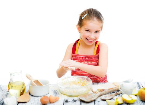 cutre little girl making dough isolated on a white background