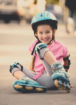 beautiful girl on the rollers in helmet and protection