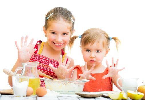 cute little sisters baking on kitchen and shows hands on a white background