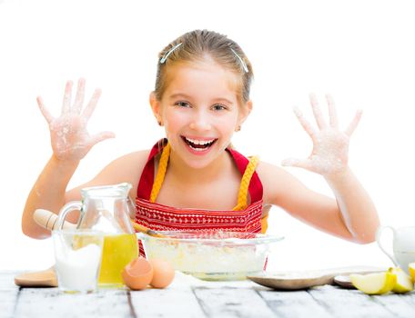 smiling little girl baking on kitchen and shows hands isolated on a white background