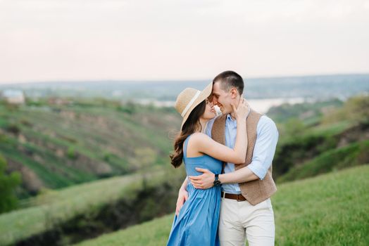 young couple a guy and a girl are walking in the green mountain hills