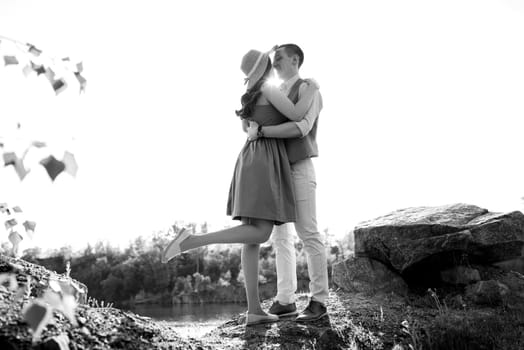 a young couple a guy and a girl are walking near a mountain lake surrounded by granite rocks